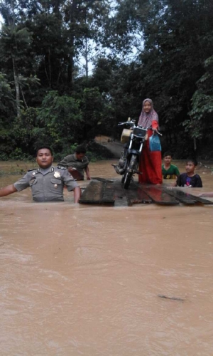 Heroik, Polisi di Kuansing Ini Nyebur Pakai Baju Dinas Demi Ungsikan Warganya dari Banjir